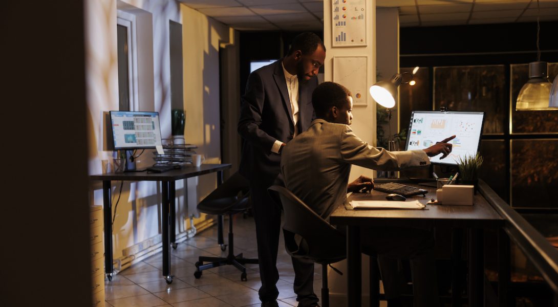 Executive managers looking at marketing statistics on computer working at financial startegy to increase company profit. Corporate employees brainstorming business ideas for profit progress